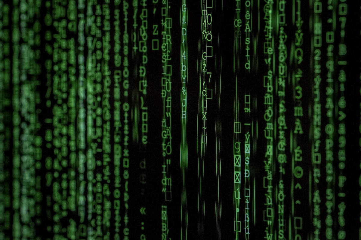 Computer screen with green code and text on dark background